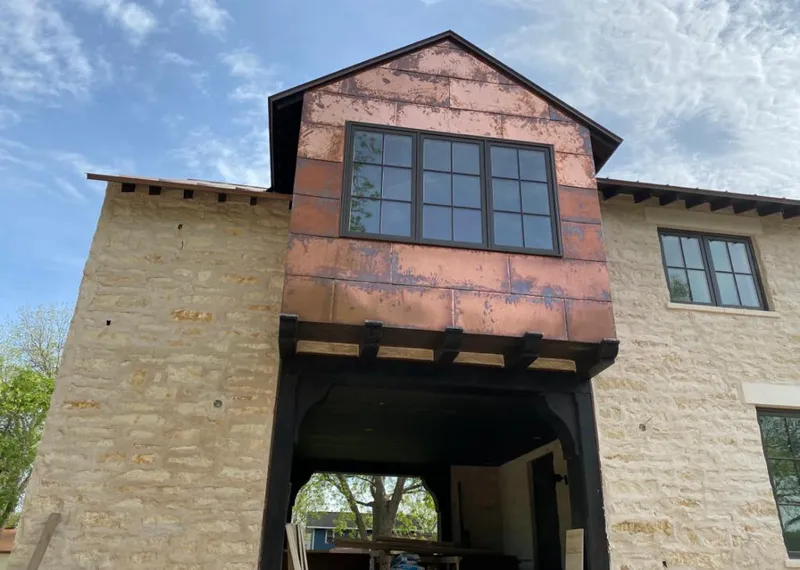 Copper metal panel facade on a stone building for Skylight Installation in Greer