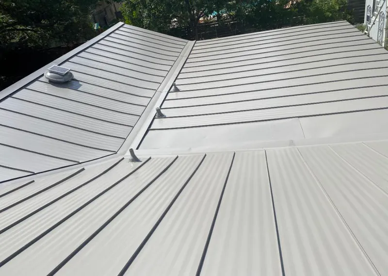 Solar attic fan installed on a metal roof for Roof Ventilation in Greer